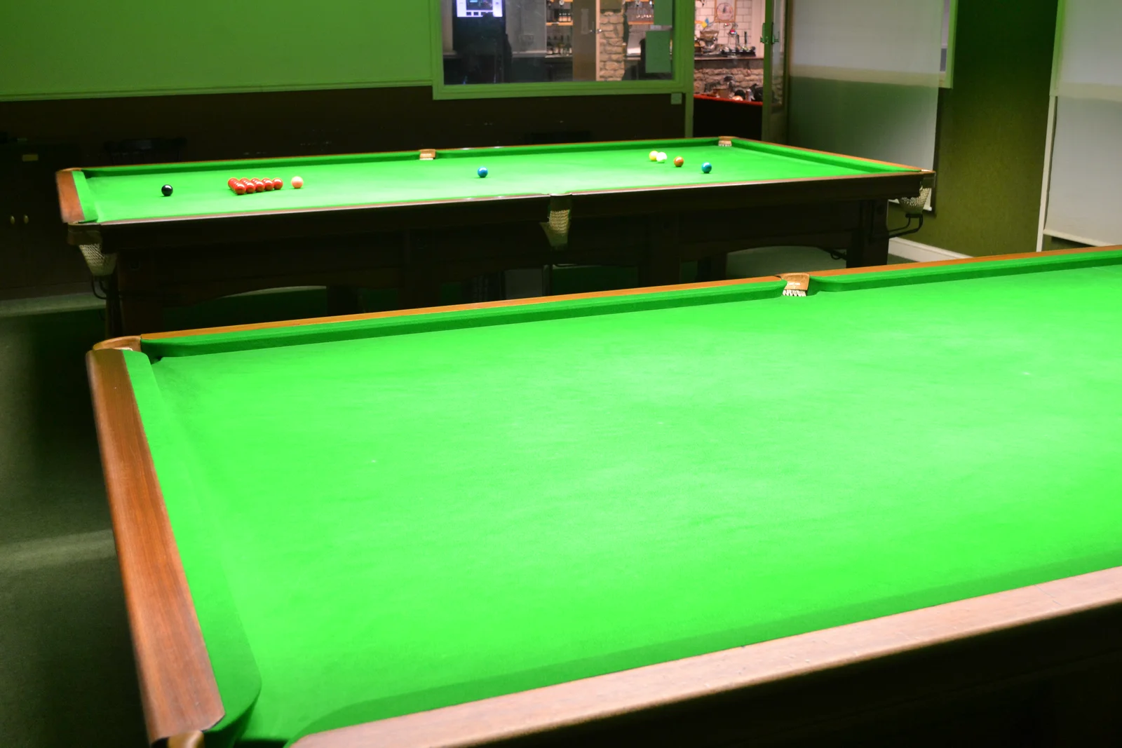 Two full-size snooker tables in the Haydon Que Club snooker room
